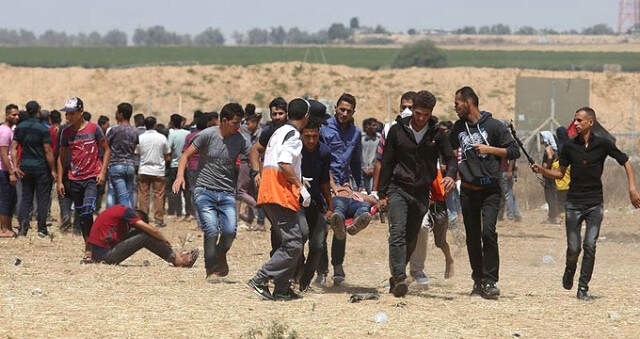 İsrail Askerleri, Anadolu Ajansı Foto Muhabirini Gerçek Mermiyle Vurarak Yaraladı İsrail Keskin Nişancısı, AA Foto Muhabirini Gerçek Mermiyle Vurarak Yaraladı