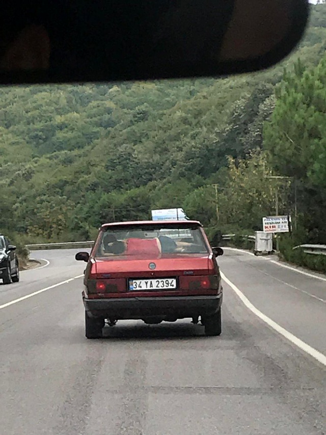 Trafikte arka cam ile koltuk arasında uyuyan çocuğu görenler şaşıp kaldı