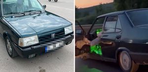 Otomobilinin sol ön kapısını açıp ayağıyla tutarak trafikte ilerledi