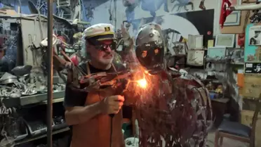 Topladığı hurda parçaları robot heykeline dönüştürüyor