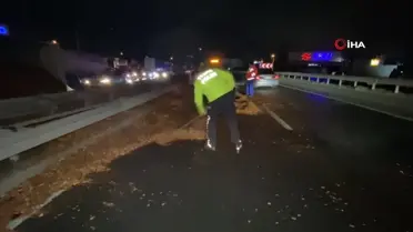 Polis eline aldığı fırçayla devrilen tırdan yola dökülen talaşı temizledi