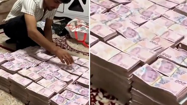 Deste deste paraları halının üzerine dizip video çekti