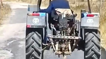 Köpeği traktöre bağlayarak sürükledi