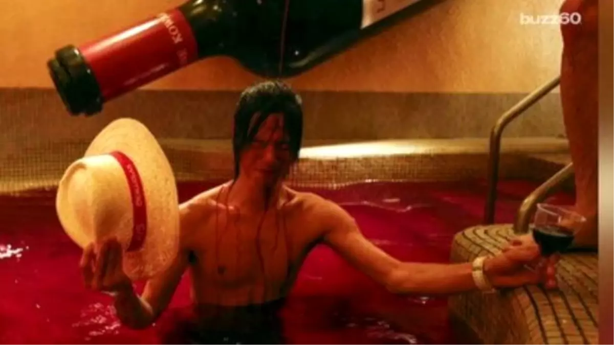 Japanese Bathe İn Pool Of Red Wine To Celebrate French Holiday