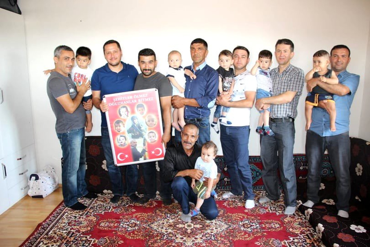Şehidin ailesi, şehidin adını taşıyan bebekler ve aileleriyle bir arada