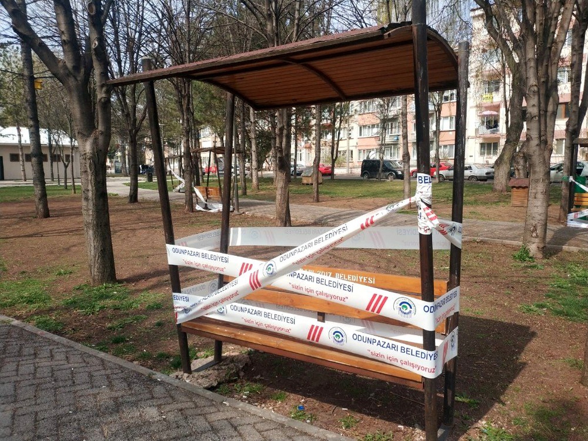 Belediye, koronavirüs nedeniyle vatandaşların evde kalmaları için banklara şerit çekti