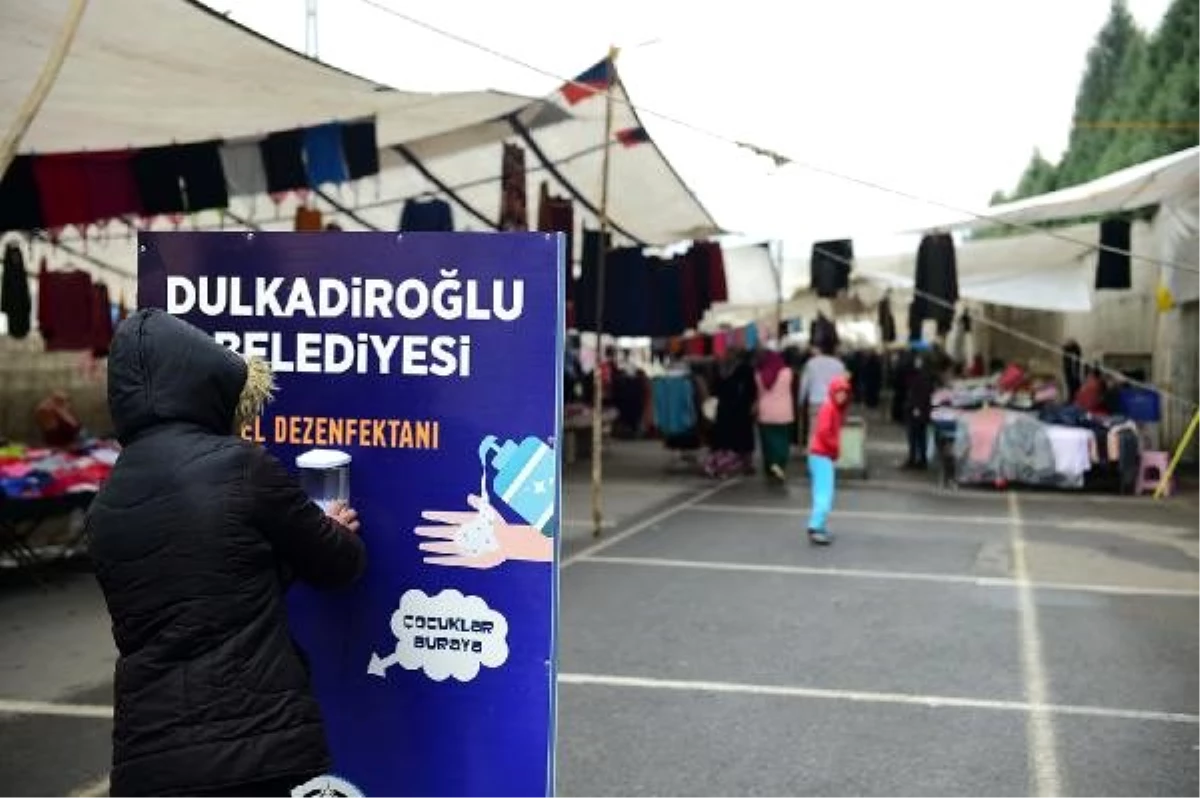 Pazar alışverişi öncesi ellerini dezenfekte ediyorlar