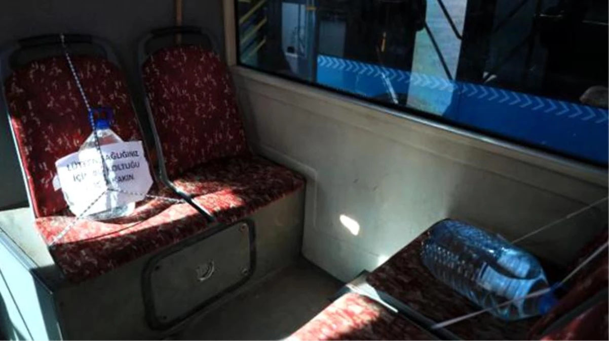 Otobüs şoföründen ilginç korona önlemi: Yasaklı koltuklara 5 litrelik bidon bağladı