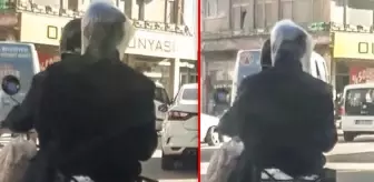 Motosikletlinin arkasındaki şahıs, başına geçirdiği poşetle koronavirüse karşı önlem aldı