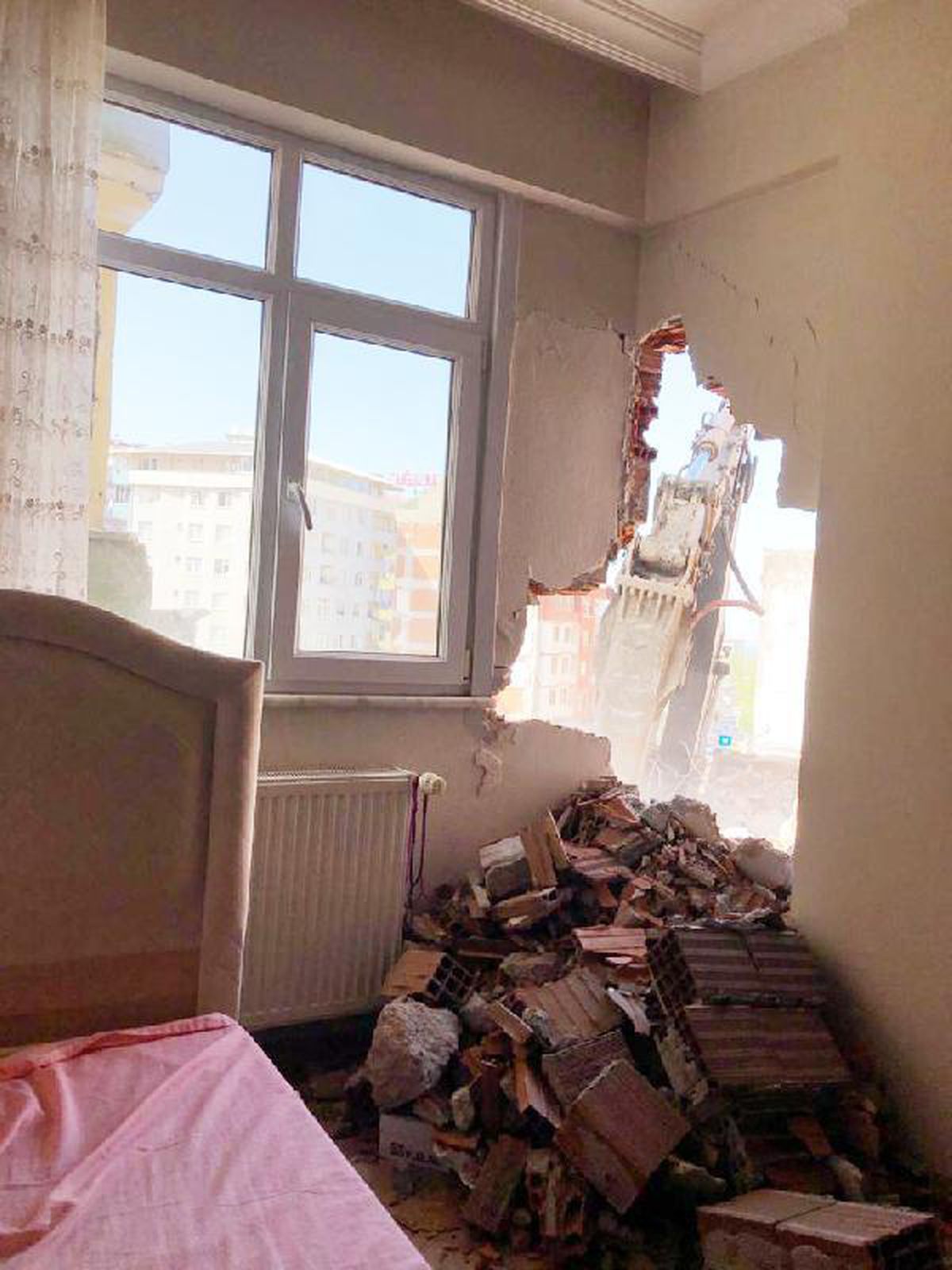 Yıkım sırasında bitişikteki evin duvarı delindi, yatak odası molozla doldu