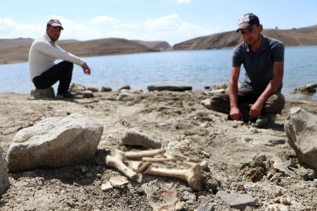 Suların çekildiği baraj gölünde mezarlar ve kemikler gün yüzüne çıktı