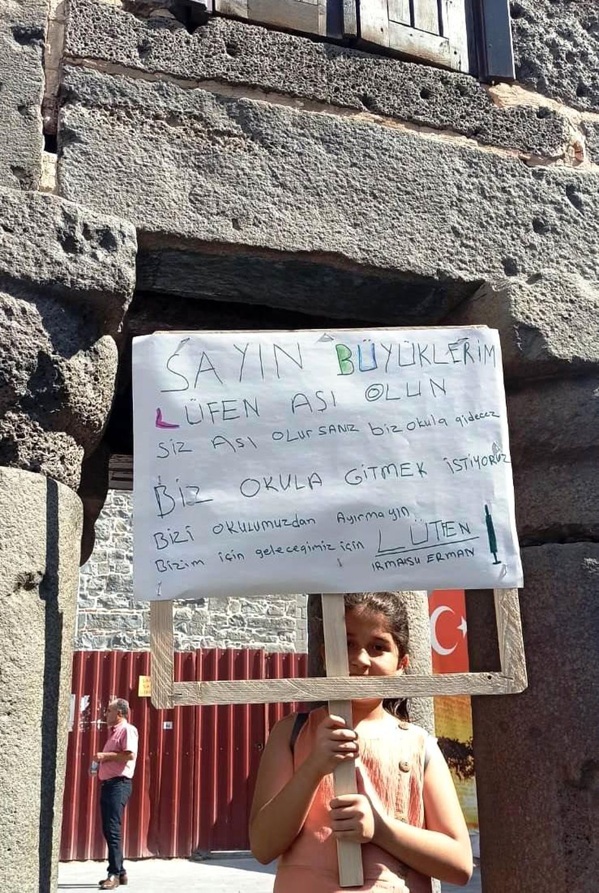 Okula gitmek için pankart açtı, sokak sokak aşıya davet etti