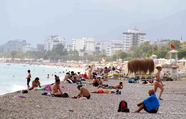 Ekim ayının ortası olmasına rağmen Konyaaltı Sahili'nde tatilciler denize girdi