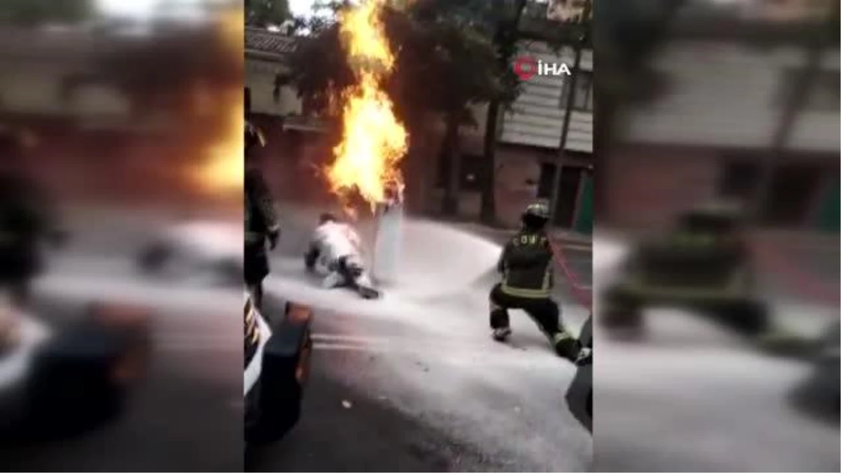 Faciayı engellemek için yanan tüp gazı sırtına alarak binadan çıkardı