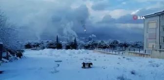 Bembeyaz kar yağışı altında, simsiyah TÜPRAŞ dumanı