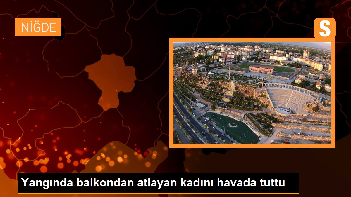 Yangında balkondan atlayan kadını havada tuttu