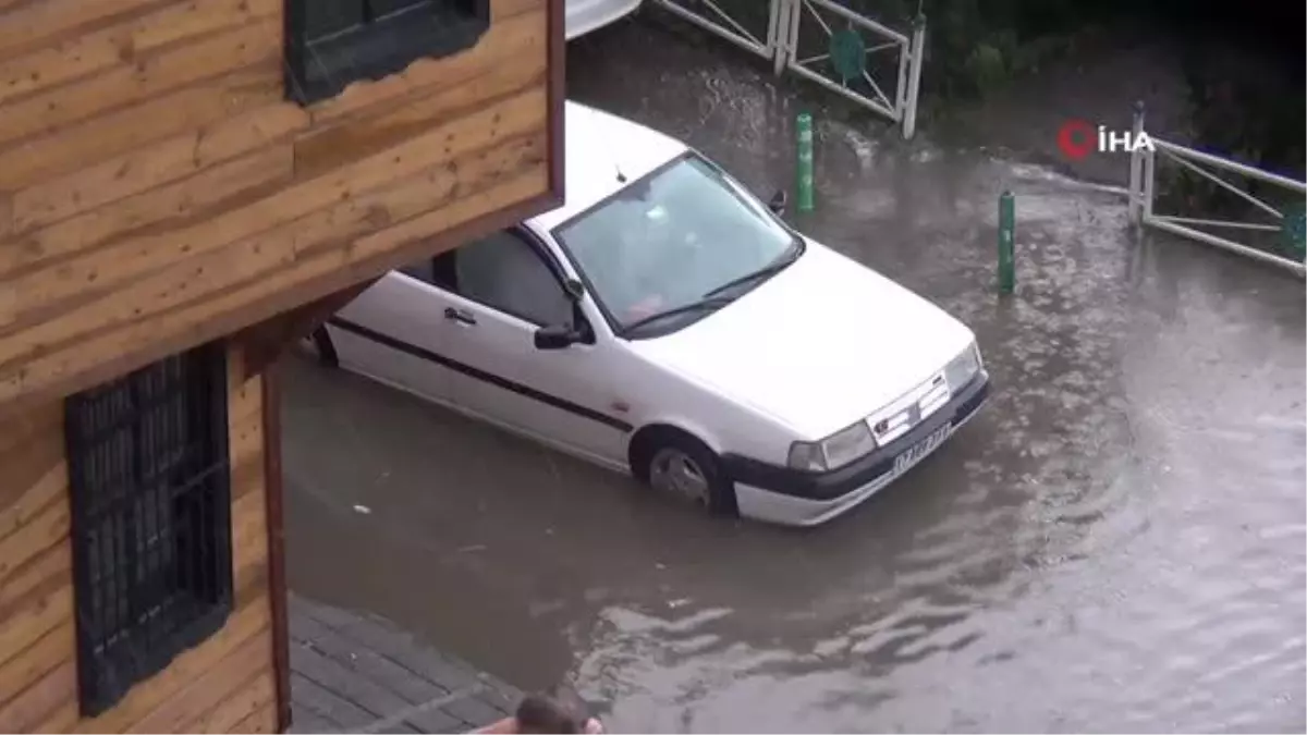 Suda mahsur kalan arabasını iterek böyle kurtardı