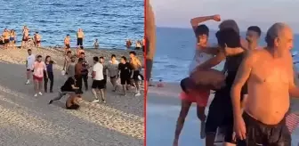 Sahilde genç kızın görüntüsünü kaydeden yabancı uyruklu şahıslar, çevredekiler tarafından dövüldü