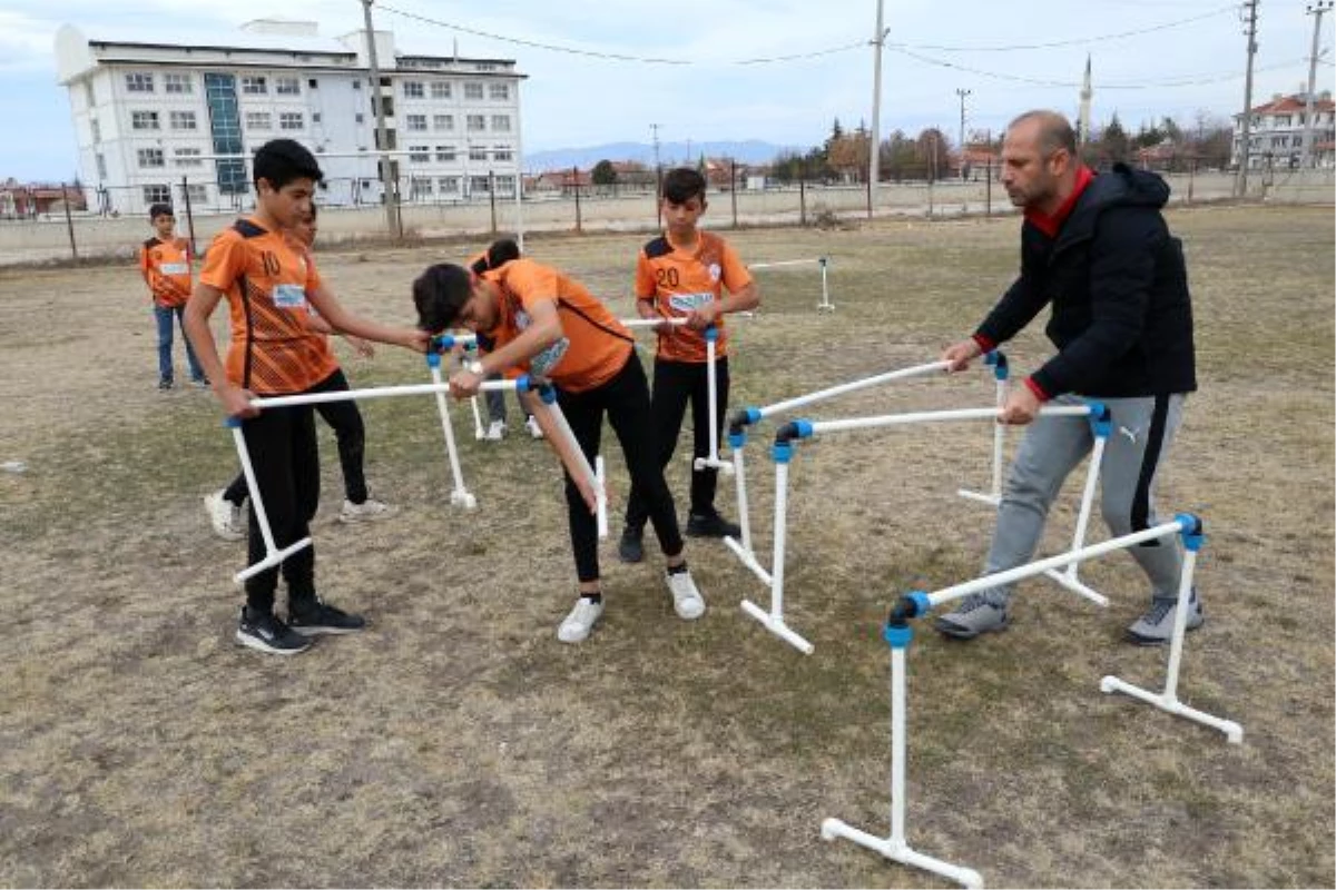 Öğrencilerini, su borularından yaptığı engelli parkuruyla yarışlara hazırlıyor