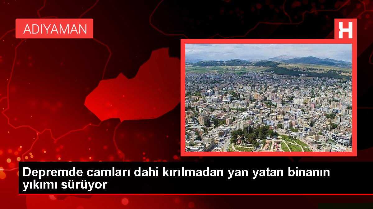 Depremde camları dahi kırılmadan yan yatan binanın yıkımı sürüyor