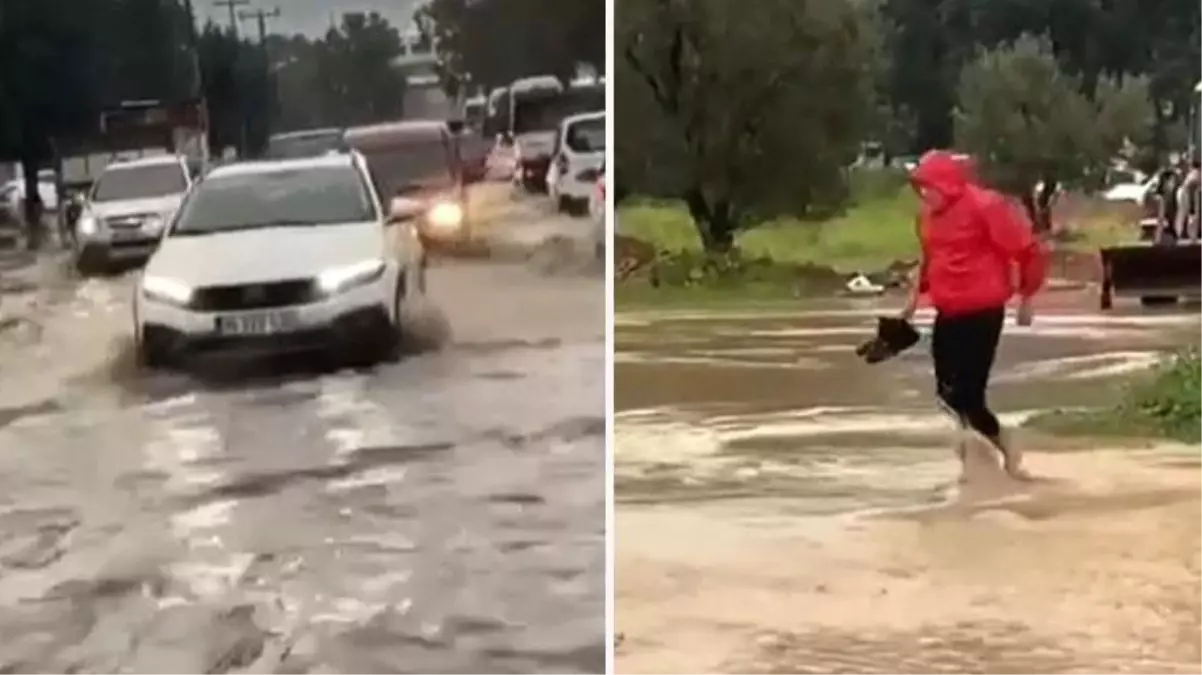 İzmir\'de sağanak yağış caddeleri göle çevirdi! Vatandaşlar sudan geçmek için ayakkabı ve çoraplarını çıkardı