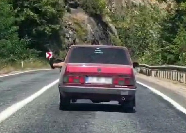 Karabük'te ayağını dışarı çıkararak seyreden sürücü kamerada