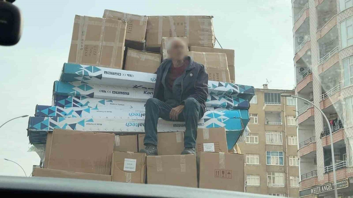 Diyarbakır\'da kolilerin üzerinde oturarak yolculuk eden kişi kameralarca görüntülendi